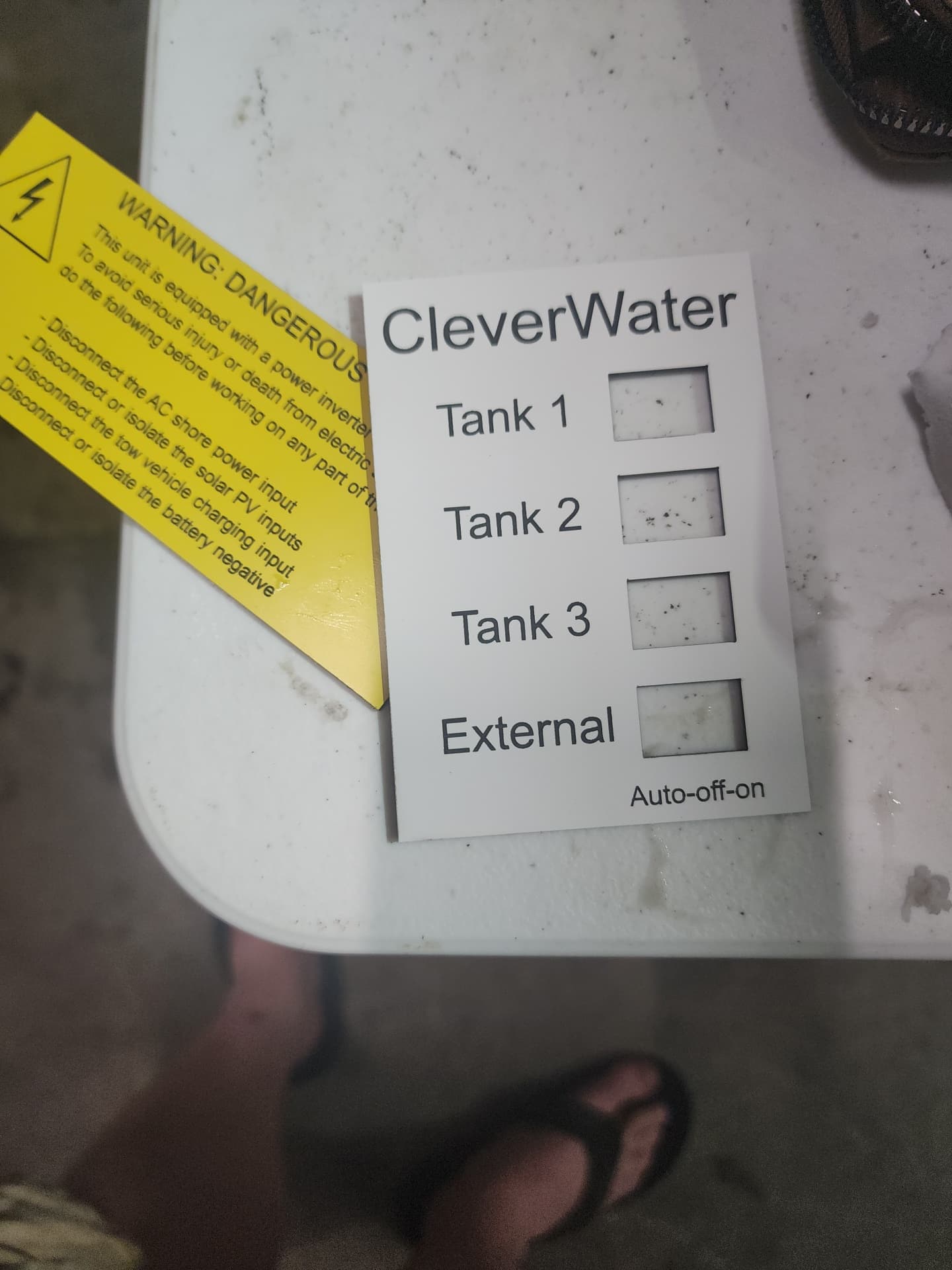 Engraved traffolyte safety signs and warning labels on the workshop bench