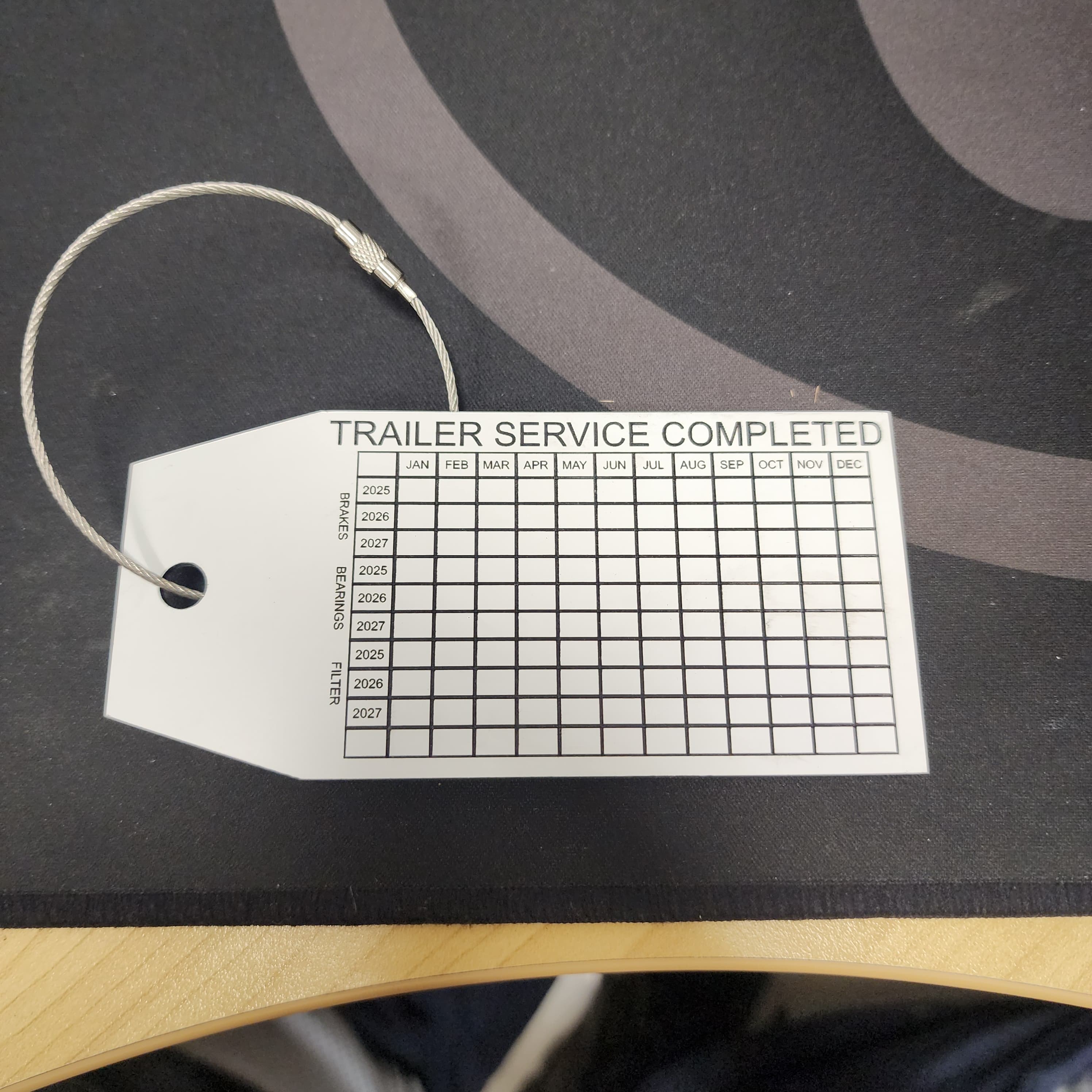 Engraved service identification tag with mounting hole
